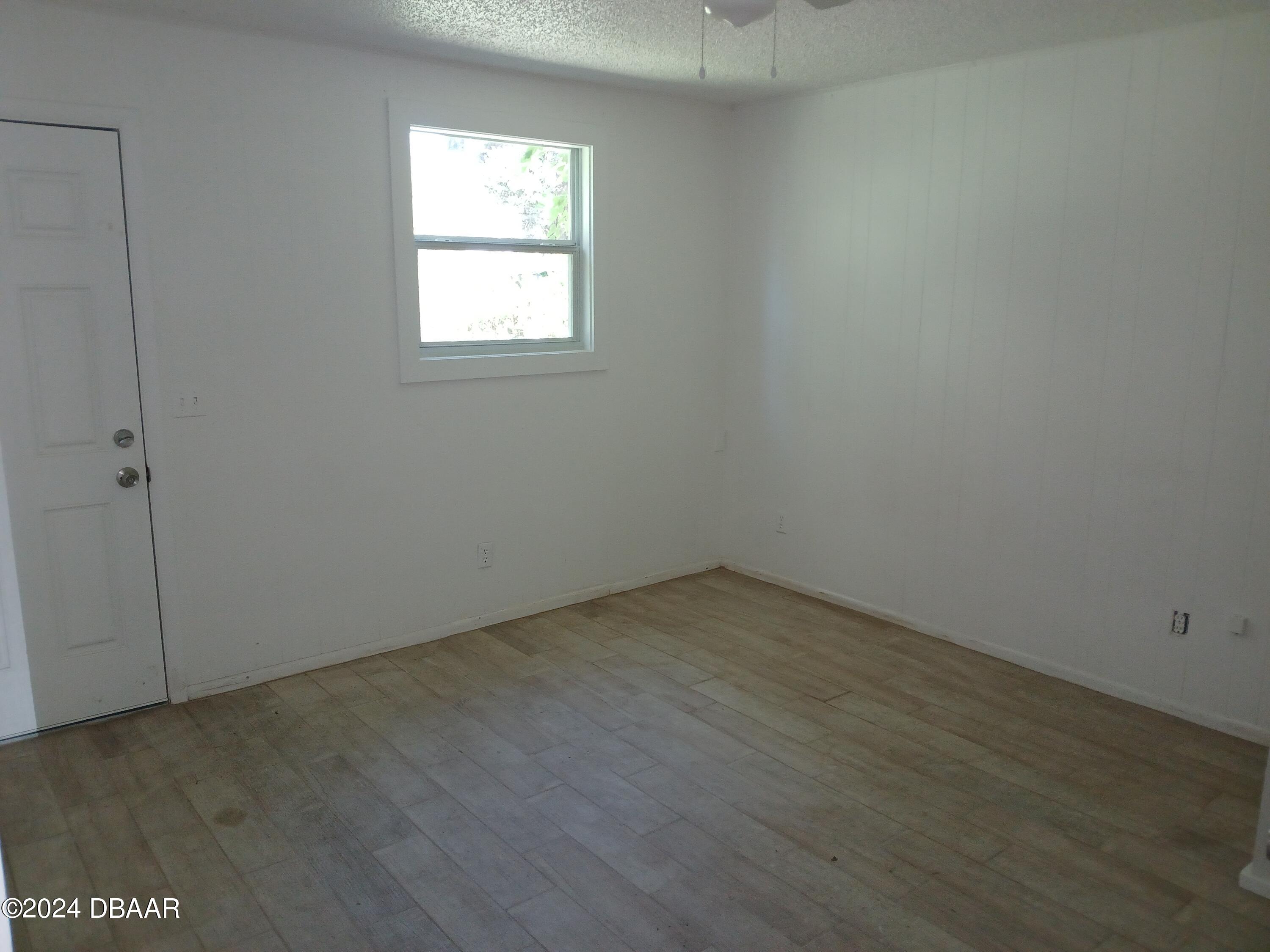 232 Summit Street Crescent City, FL 32112 - Photo 5 of 12 an empty room with wooden floor and windows
