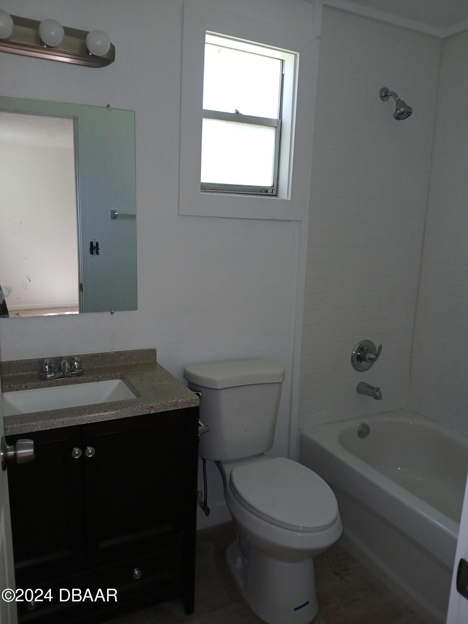 232 Summit Street Crescent City, FL 32112 - Photo 7 of 12 a bathroom with a granite countertop toilet a sink and a bathtub