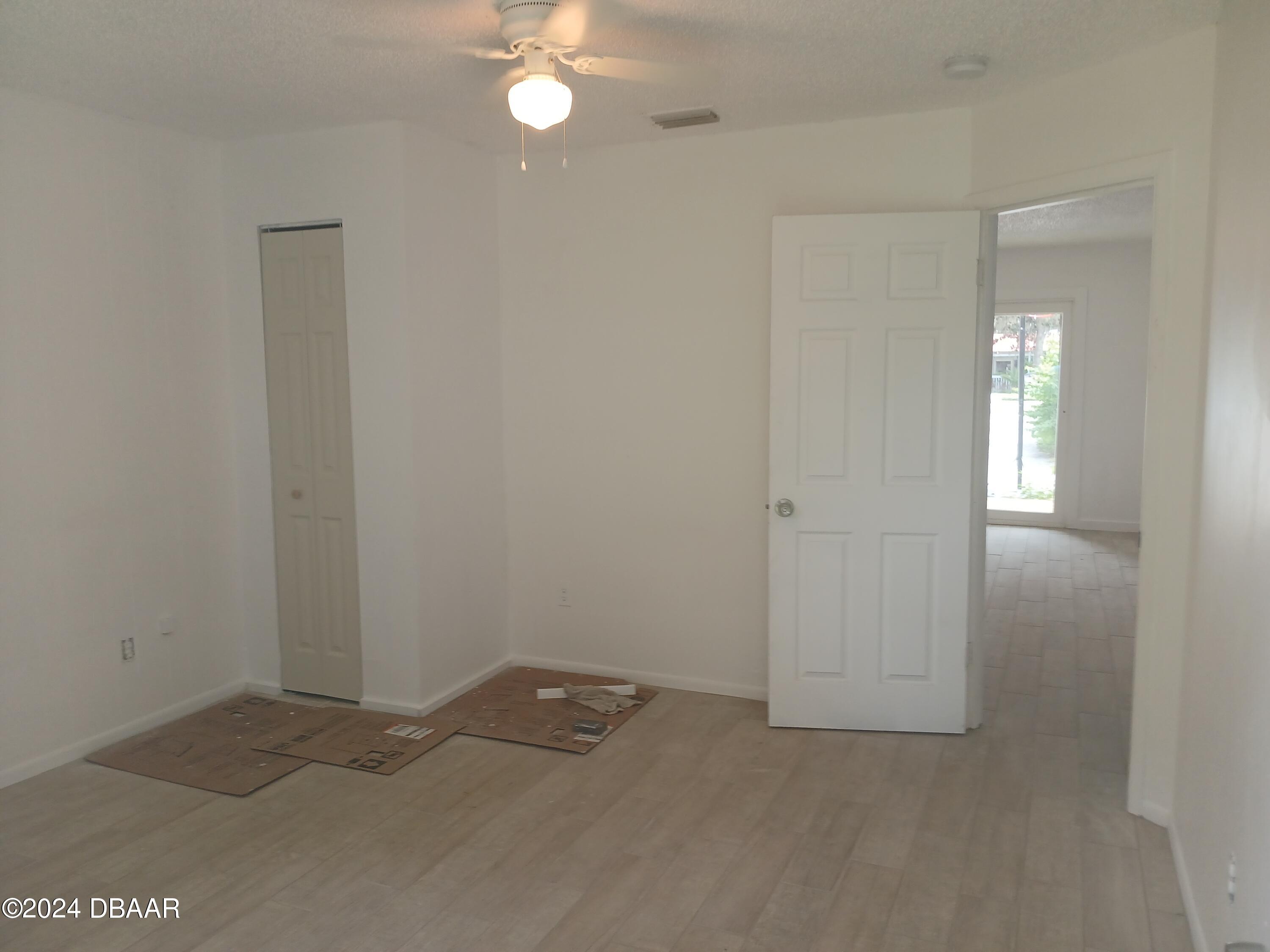 232 Summit Street Crescent City, FL 32112 - Photo 8 of 12 an empty room with chandelier fan