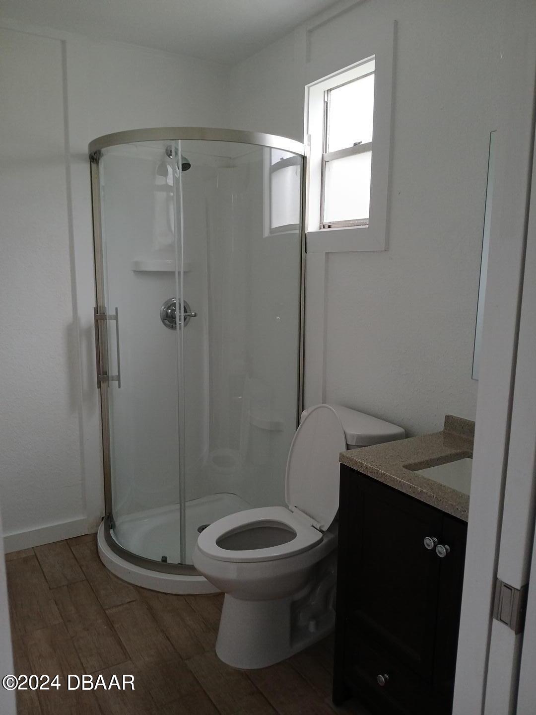 232 Summit Street Crescent City, FL 32112 - Photo 10 of 12 a bathroom with a granite countertop toilet a sink and shower