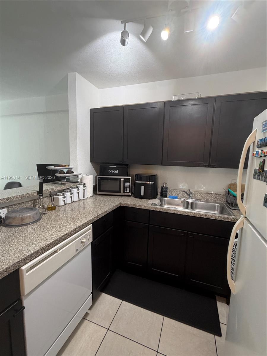 2536 Northwest 24th Street, Unit 3F Miami, FL 33142 - Photo 13 of 17 a kitchen with stainless steel appliances granite countertop a sink and a stove