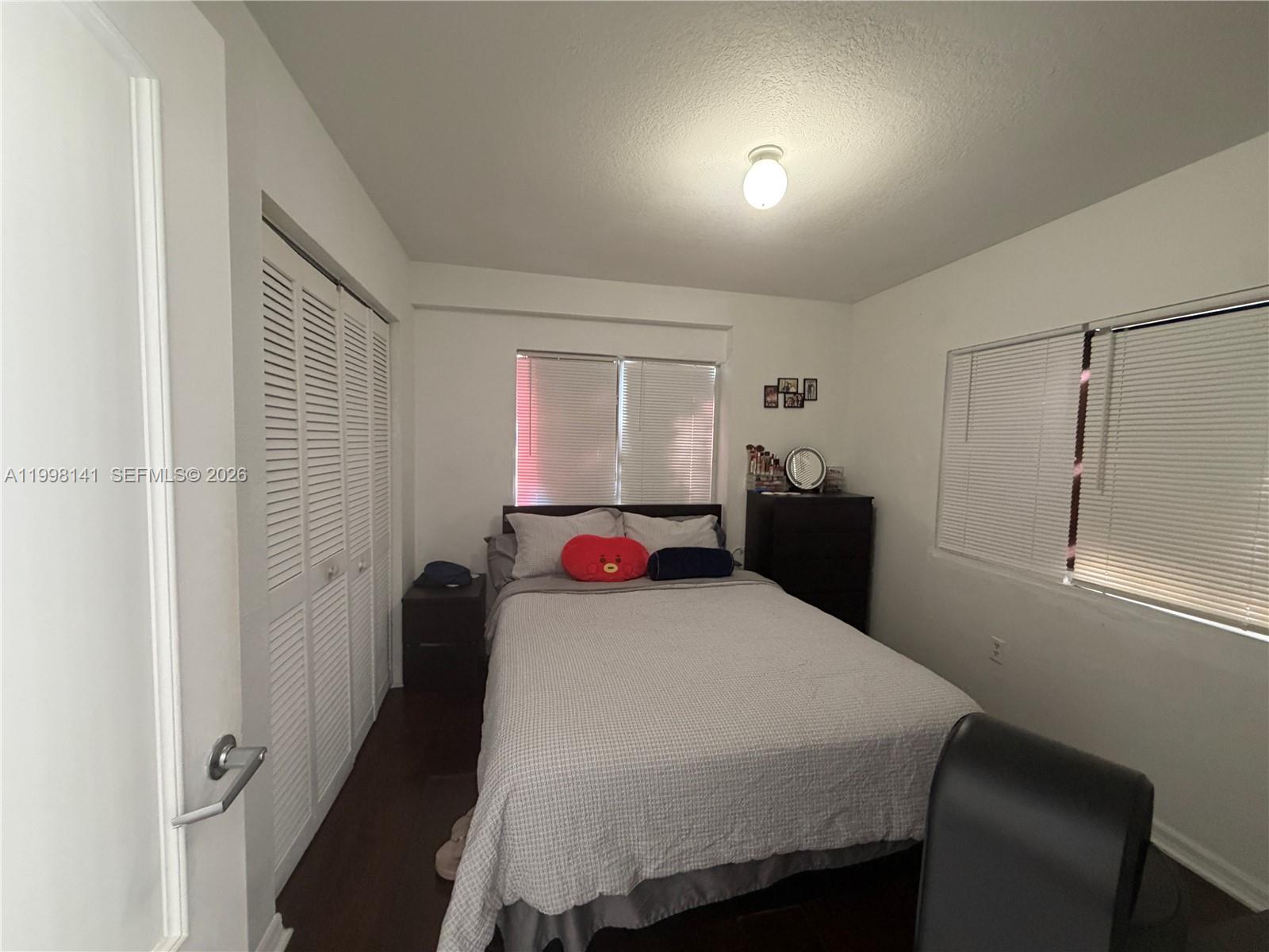 2536 Northwest 24th Street, Unit 3F Miami, FL 33142 - Photo 16 of 17 a bedroom with a bed and a mirror