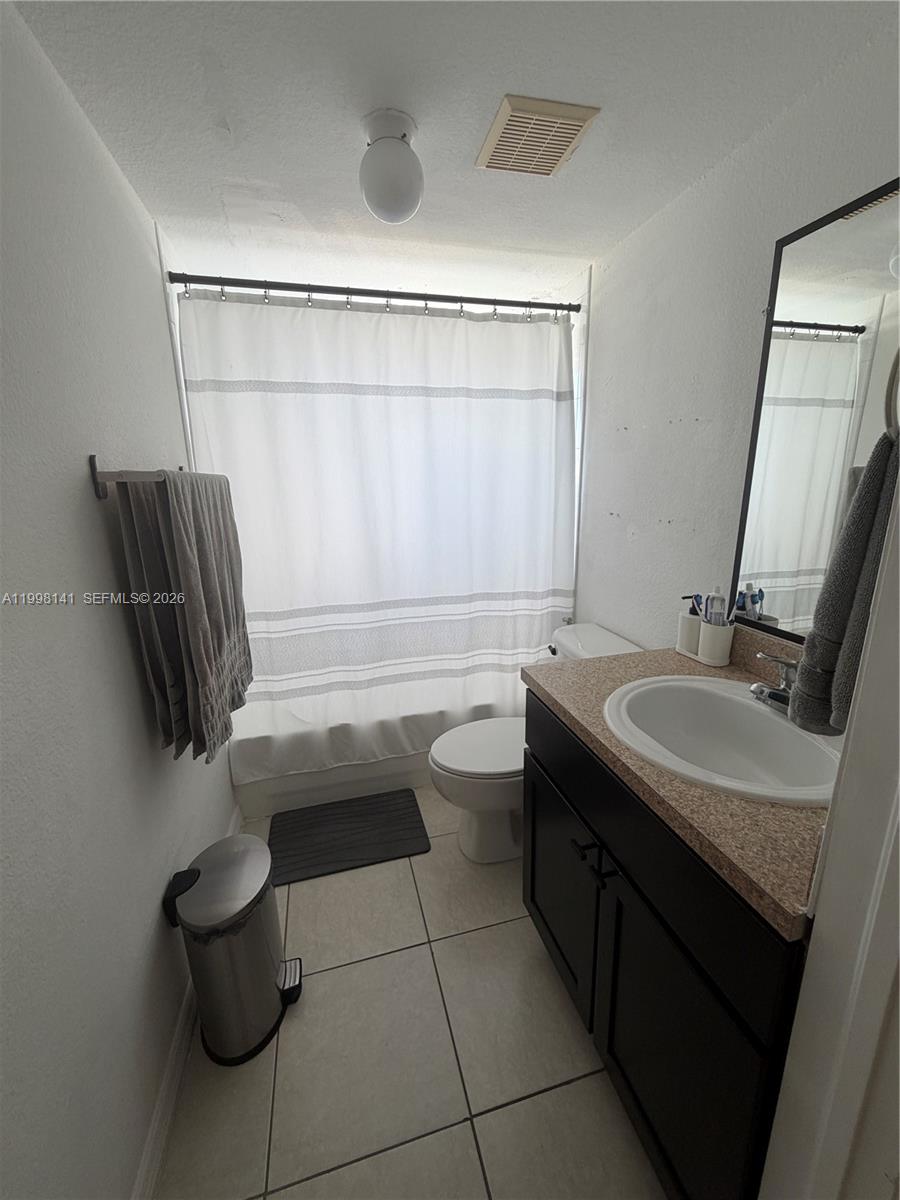 2536 Northwest 24th Street, Unit 3F Miami, FL 33142 - Photo 17 of 17 a bathroom with a sink a toilet and tub