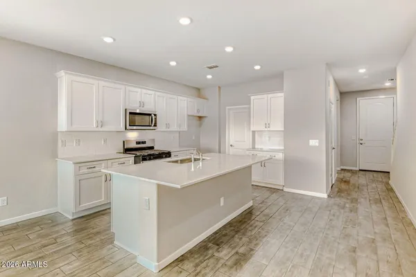a kitchen with white cabinets and white appliances