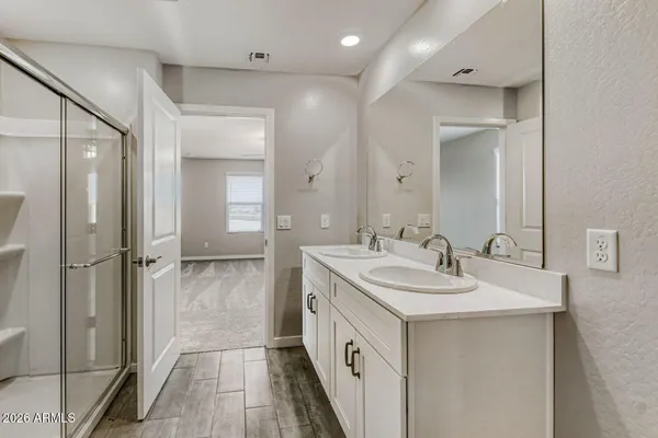 a spacious bathroom with a double vanity sink mirror and double
