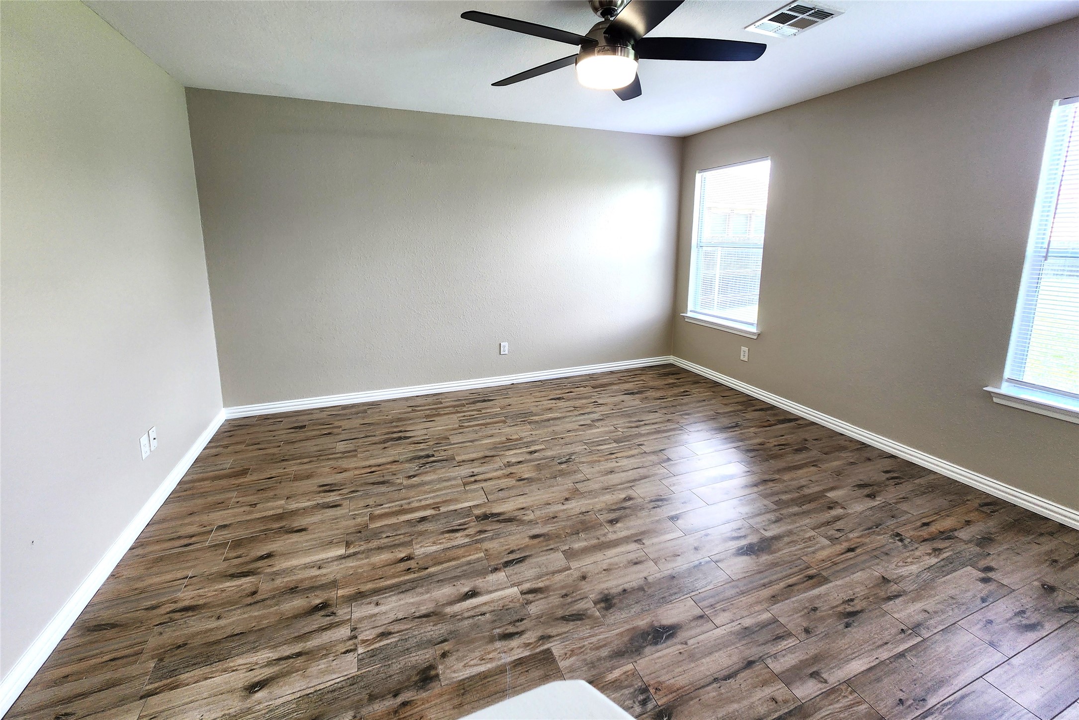 933 Meadow Ridge Loop Georgetown, TX 78626 - Photo 14 of 28 wooden floor in an empty room with a window