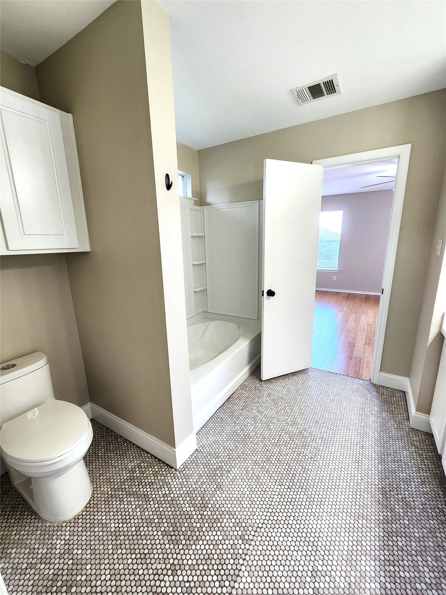 933 Meadow Ridge Loop Georgetown, TX 78626 - Photo 20 of 28 a bathroom with a toilet and a shower