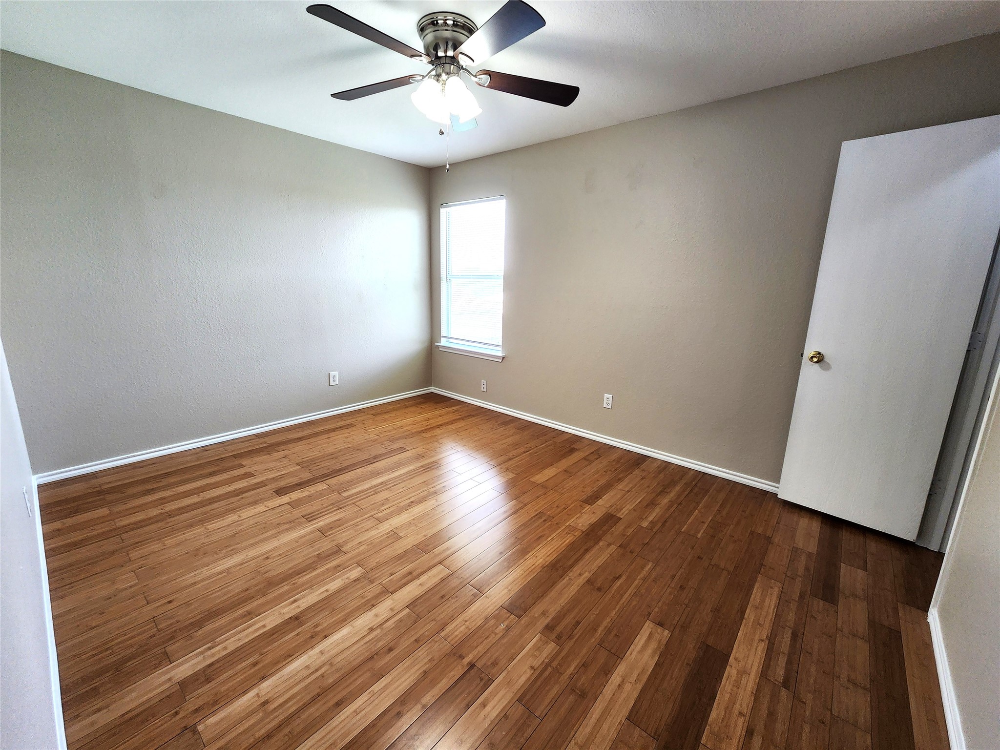933 Meadow Ridge Loop Georgetown, TX 78626 - Photo 21 of 28 a view of an empty room with wooden floor and a ceiling fan