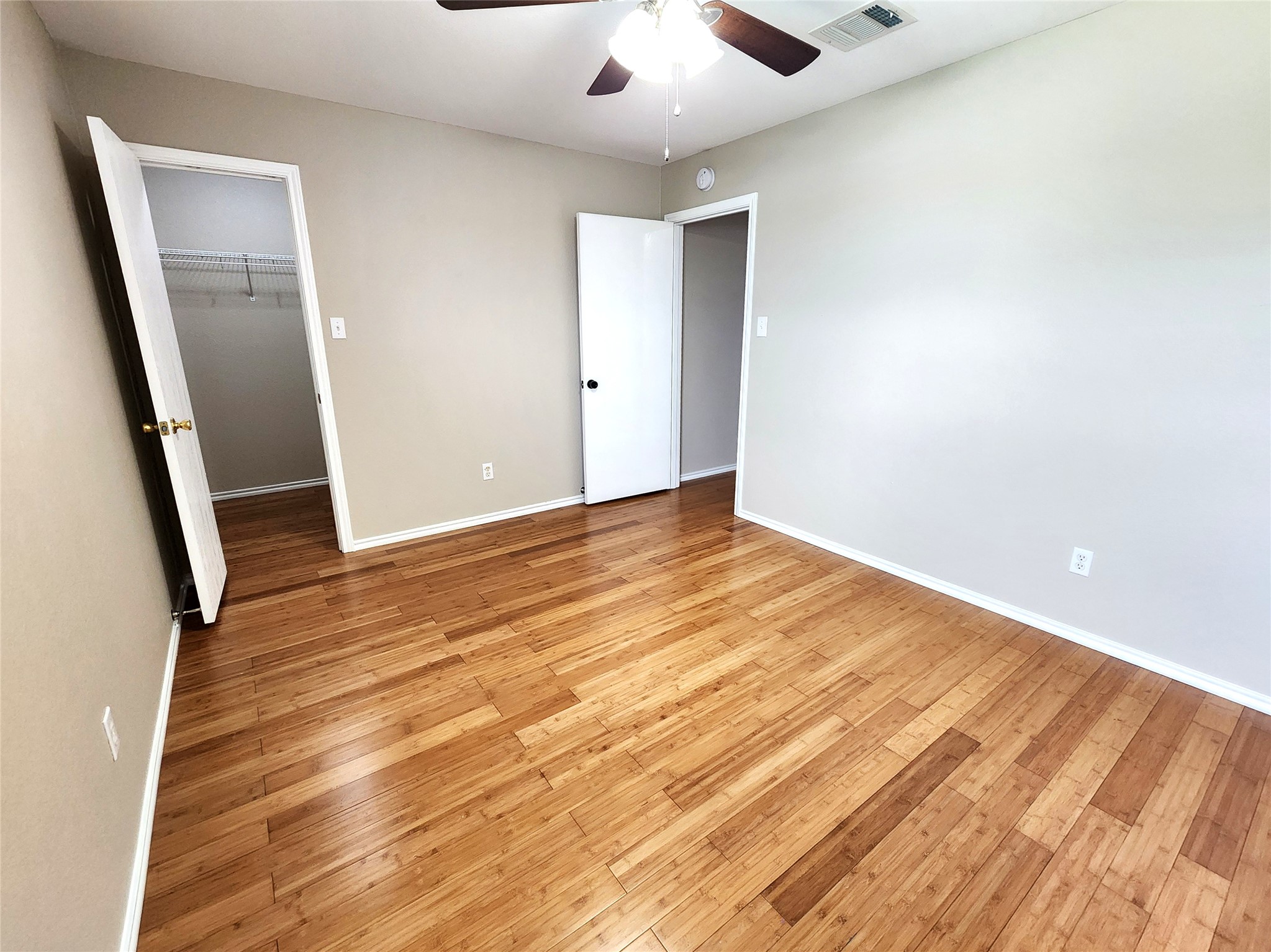 933 Meadow Ridge Loop Georgetown, TX 78626 - Photo 22 of 28 an empty room with wooden floor and entrance