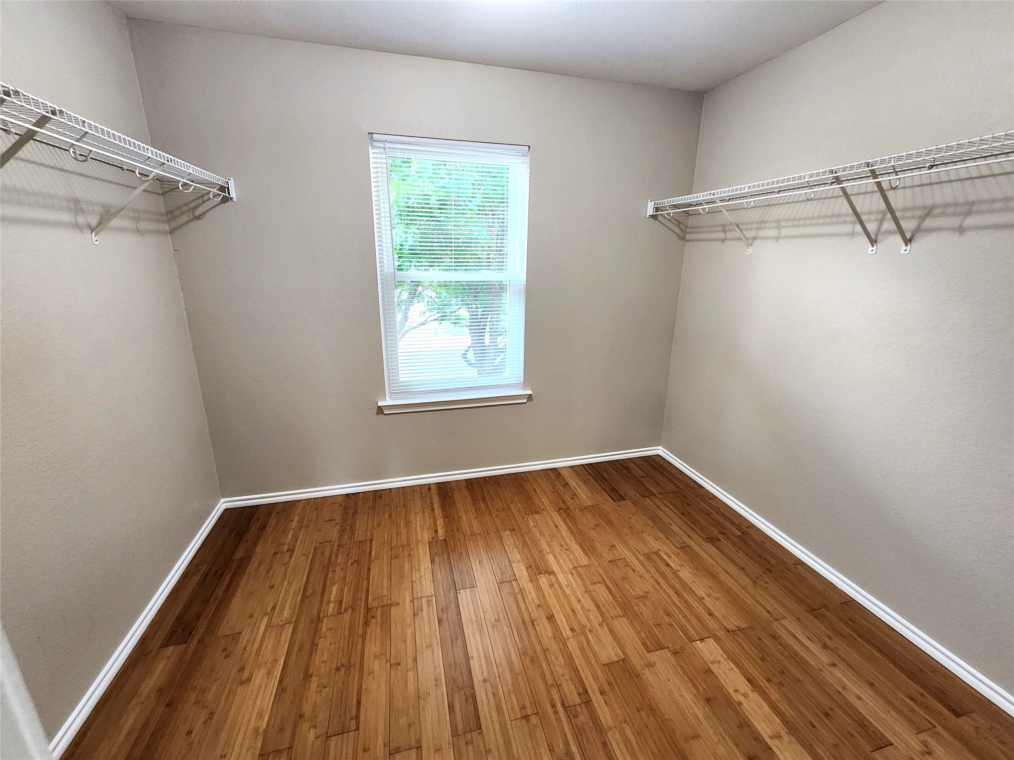 933 Meadow Ridge Loop Georgetown, TX 78626 - Photo 28 of 28 a view of an empty room with wooden floor and a window