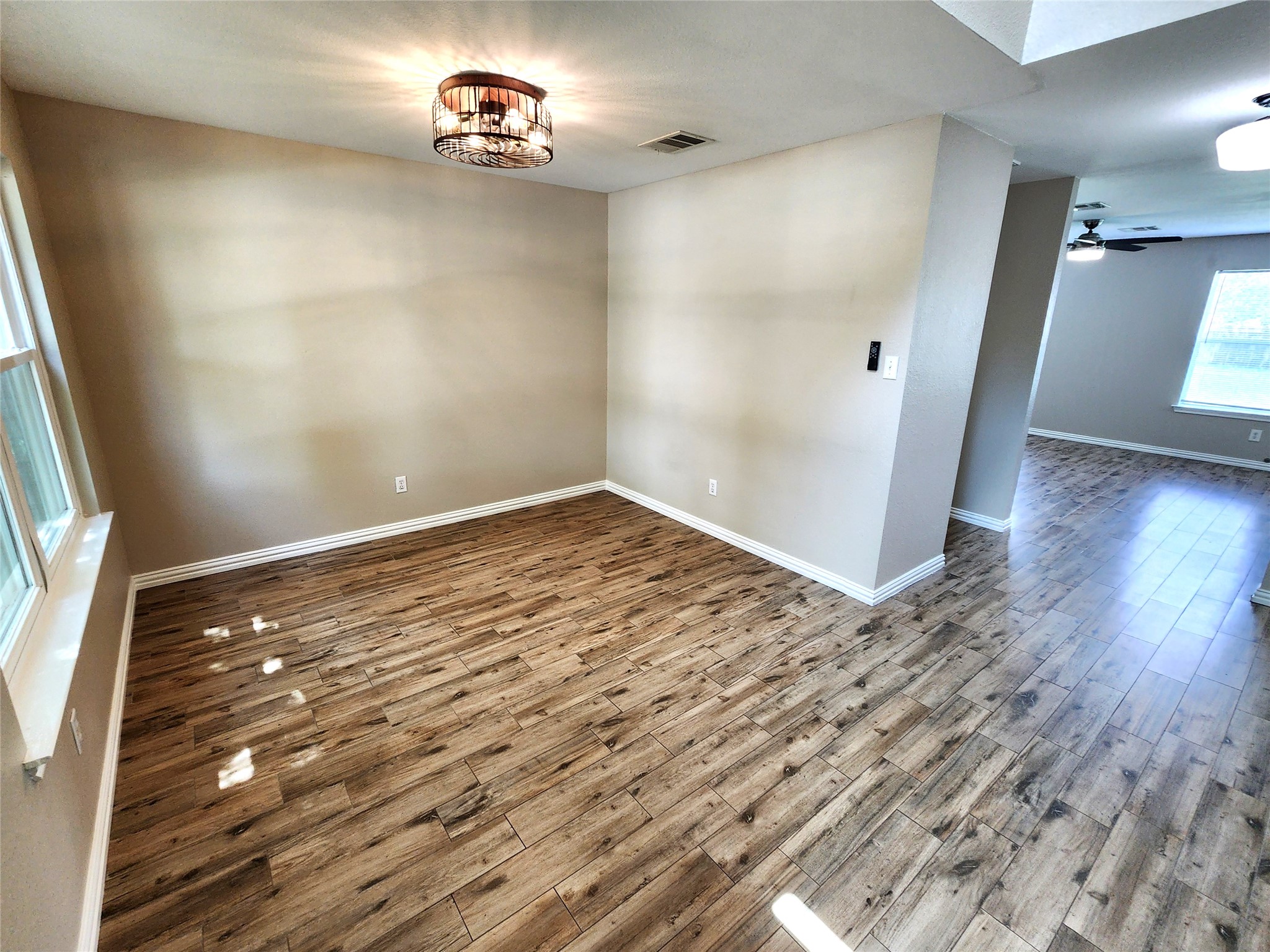 933 Meadow Ridge Loop Georgetown, TX 78626 - Photo 9 of 28 an empty room with wooden floor and windows
