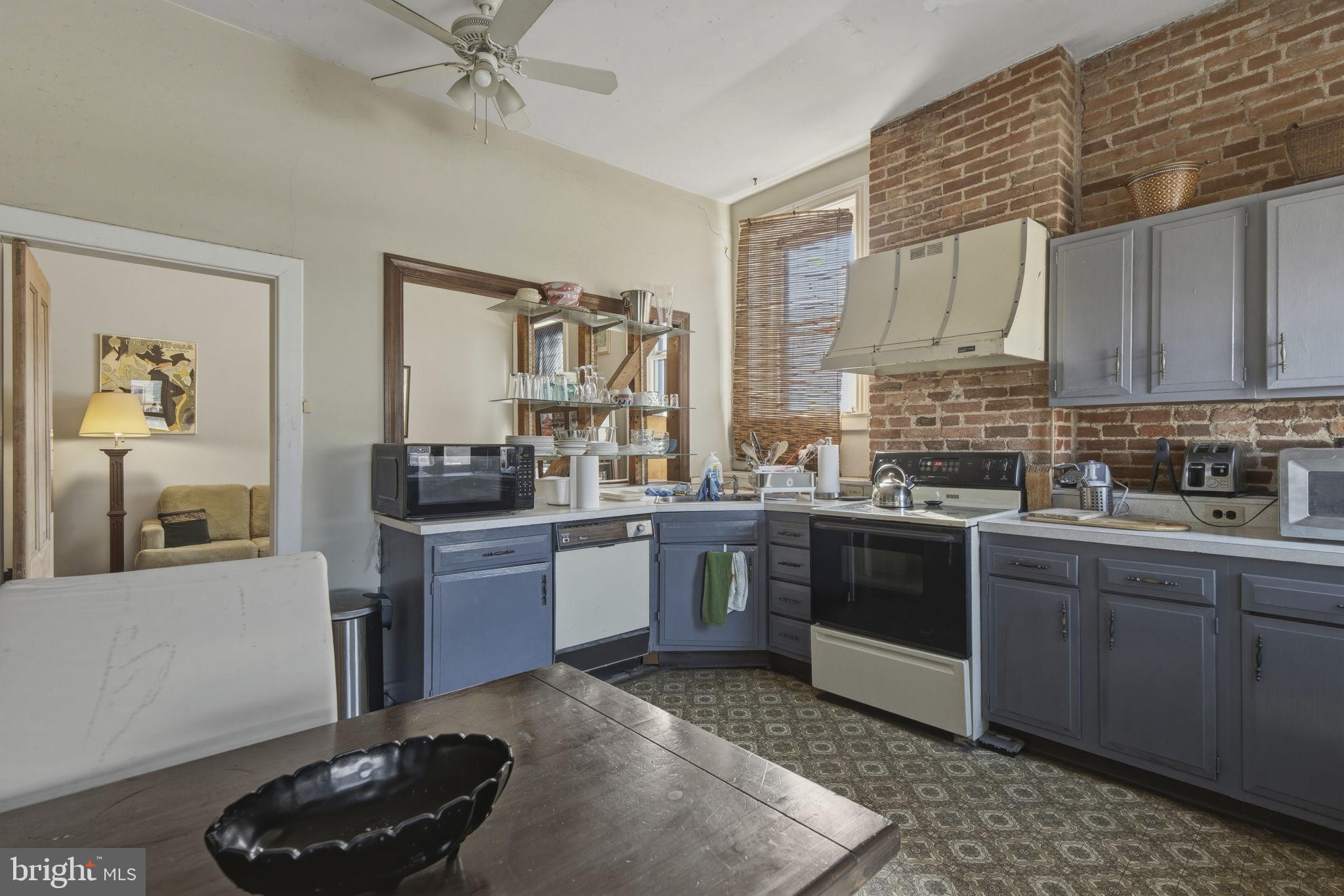 222 West Madison Street Baltimore, MD 21201 - Photo 13 of 40 a kitchen with stainless steel appliances kitchen island granite countertop a stove and cabinets