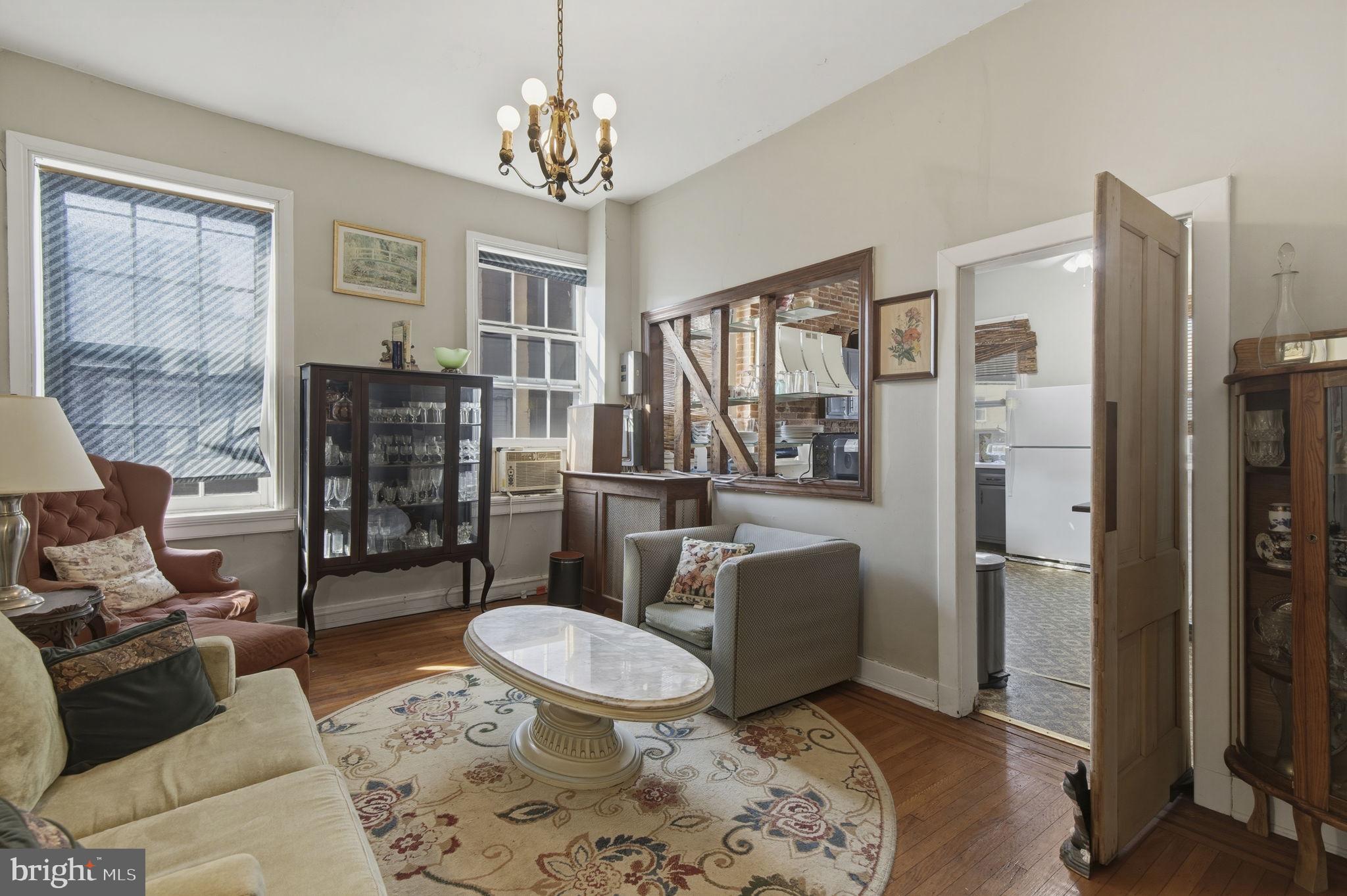 222 West Madison Street Baltimore, MD 21201 - Photo 14 of 40 a living room with furniture a lamp and a chandelier