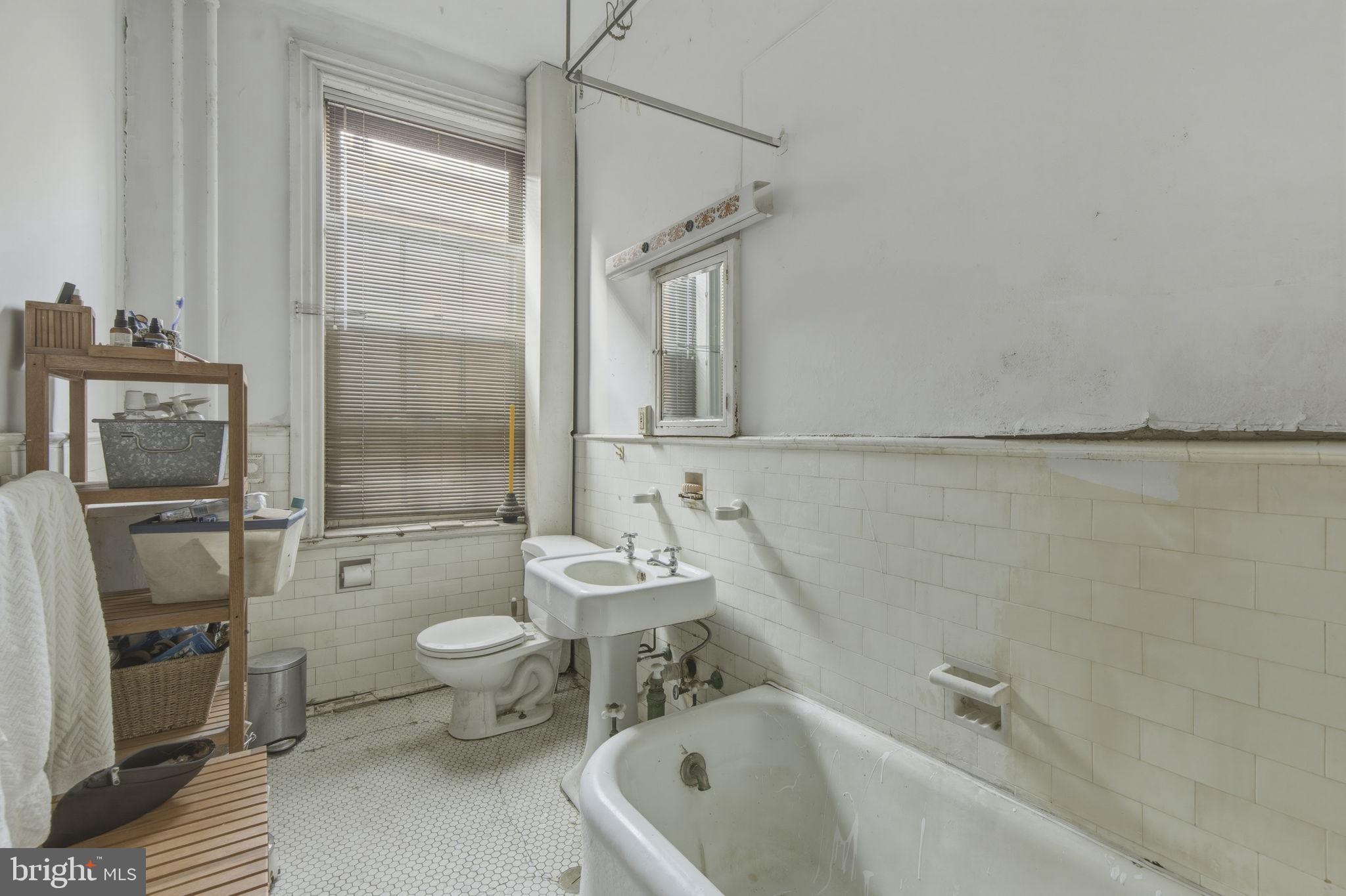 222 West Madison Street Baltimore, MD 21201 - Photo 23 of 40 a bathroom with a sink toilet and shower