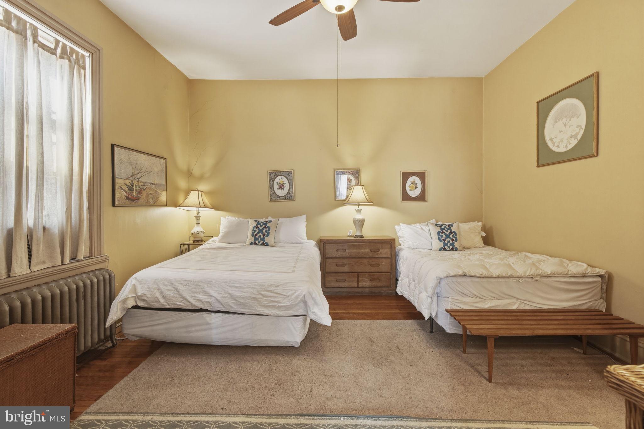 222 West Madison Street Baltimore, MD 21201 - Photo 29 of 40 a bedroom with a bed and painting on the wall