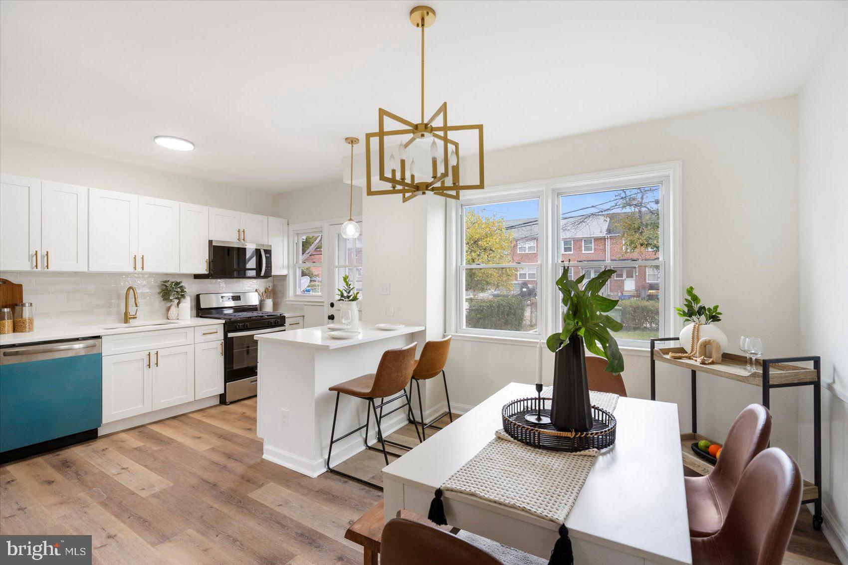 1656 Ramblewood Road Baltimore, MD 21239 - Photo 11 of 40 a dining room with furniture potted plants and wooden floor