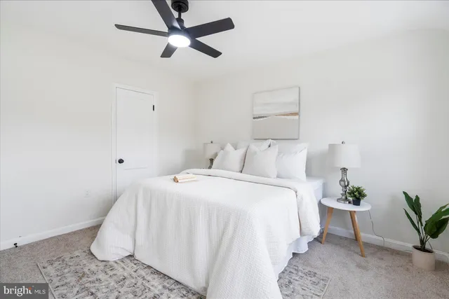 a bedroom with a bed and a potted plant