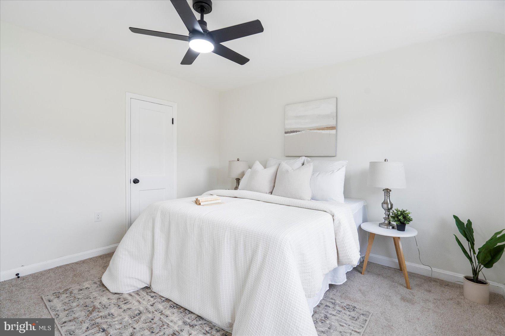 1656 Ramblewood Road Baltimore, MD 21239 - Photo 27 of 40 a bedroom with a bed and a potted plant