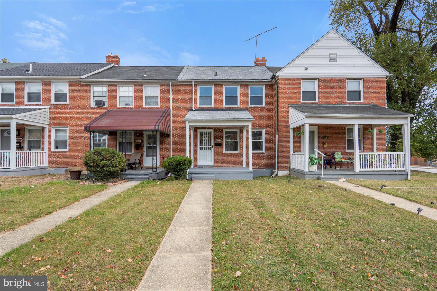 1656 Ramblewood Road Baltimore, MD 21239 - Photo 3 of 40 front view of a brick house with a yard