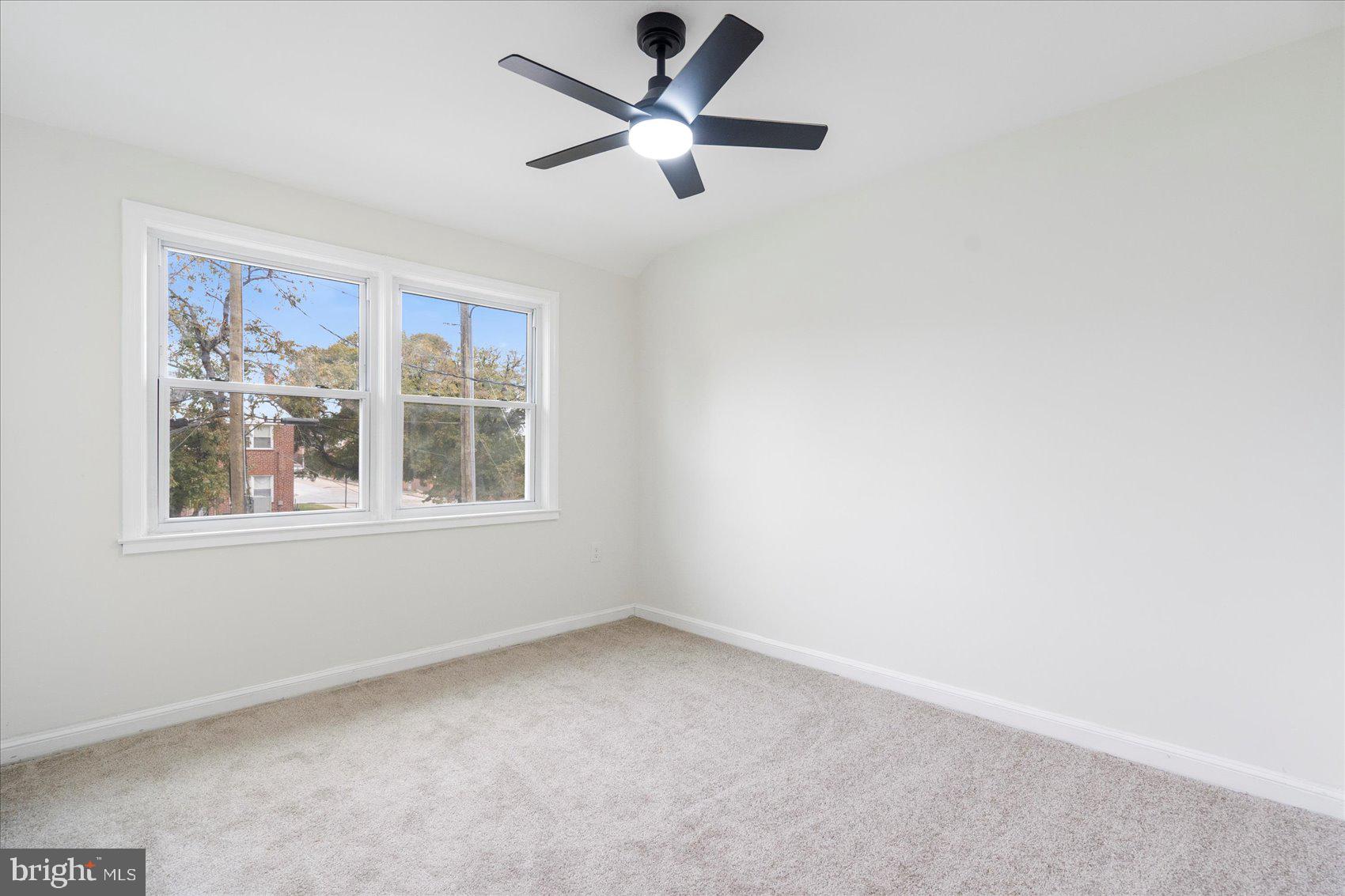 1656 Ramblewood Road Baltimore, MD 21239 - Photo 31 of 40 an empty room with a window and a fan