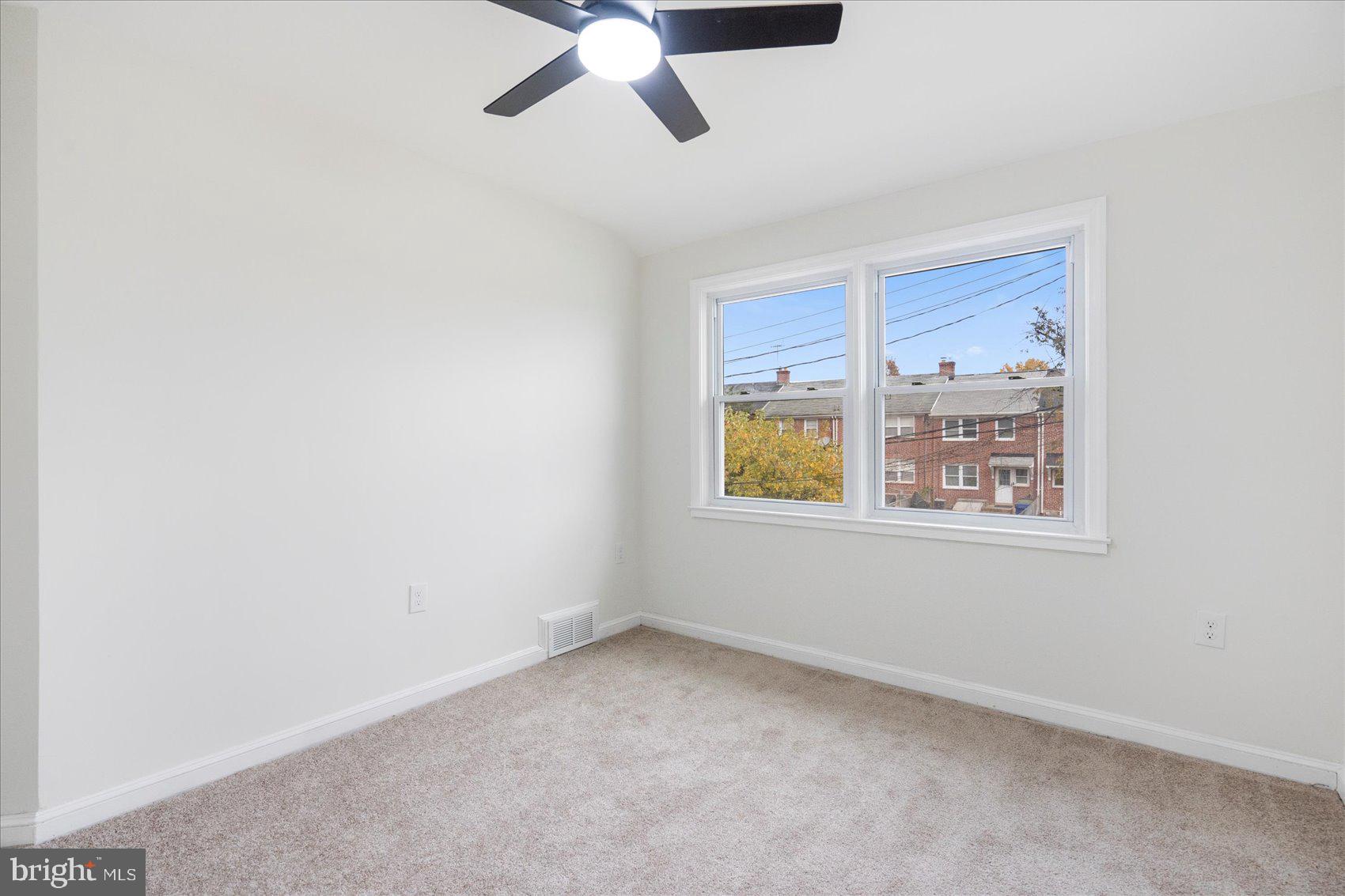 1656 Ramblewood Road Baltimore, MD 21239 - Photo 33 of 40 an empty room with windows and fan