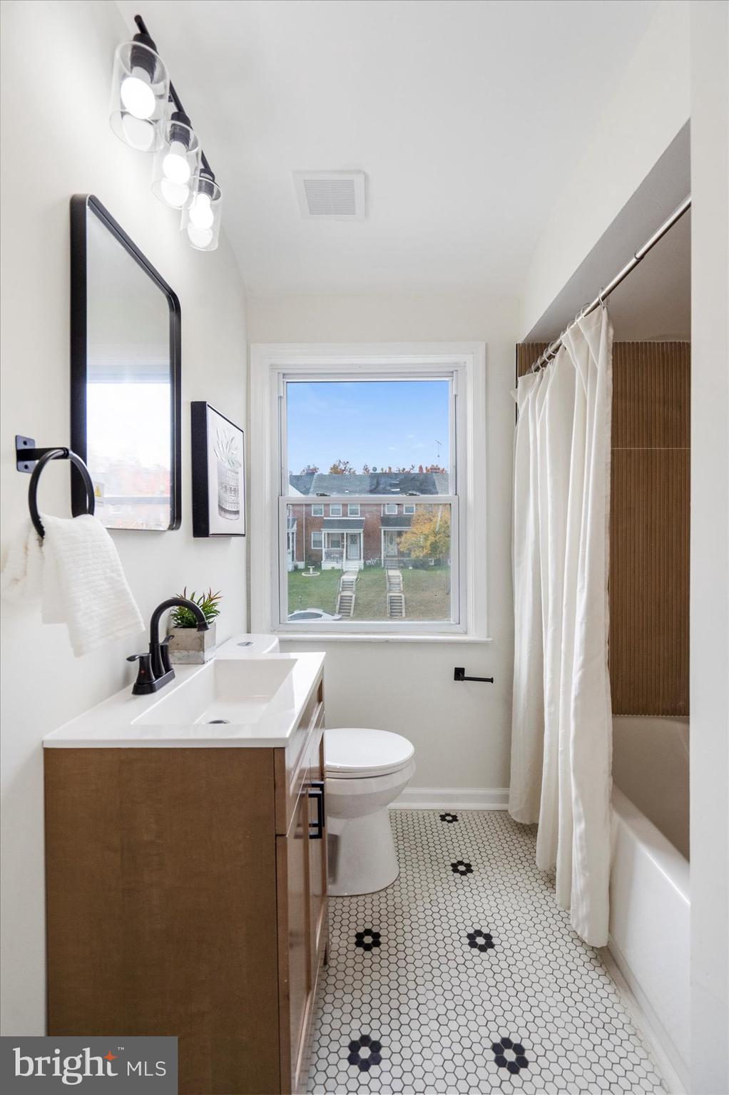 1656 Ramblewood Road Baltimore, MD 21239 - Photo 35 of 40 a bathroom with a sink a toilet and shower