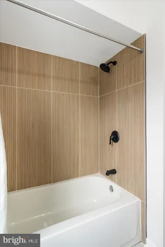 a bathroom with a tub and a shower