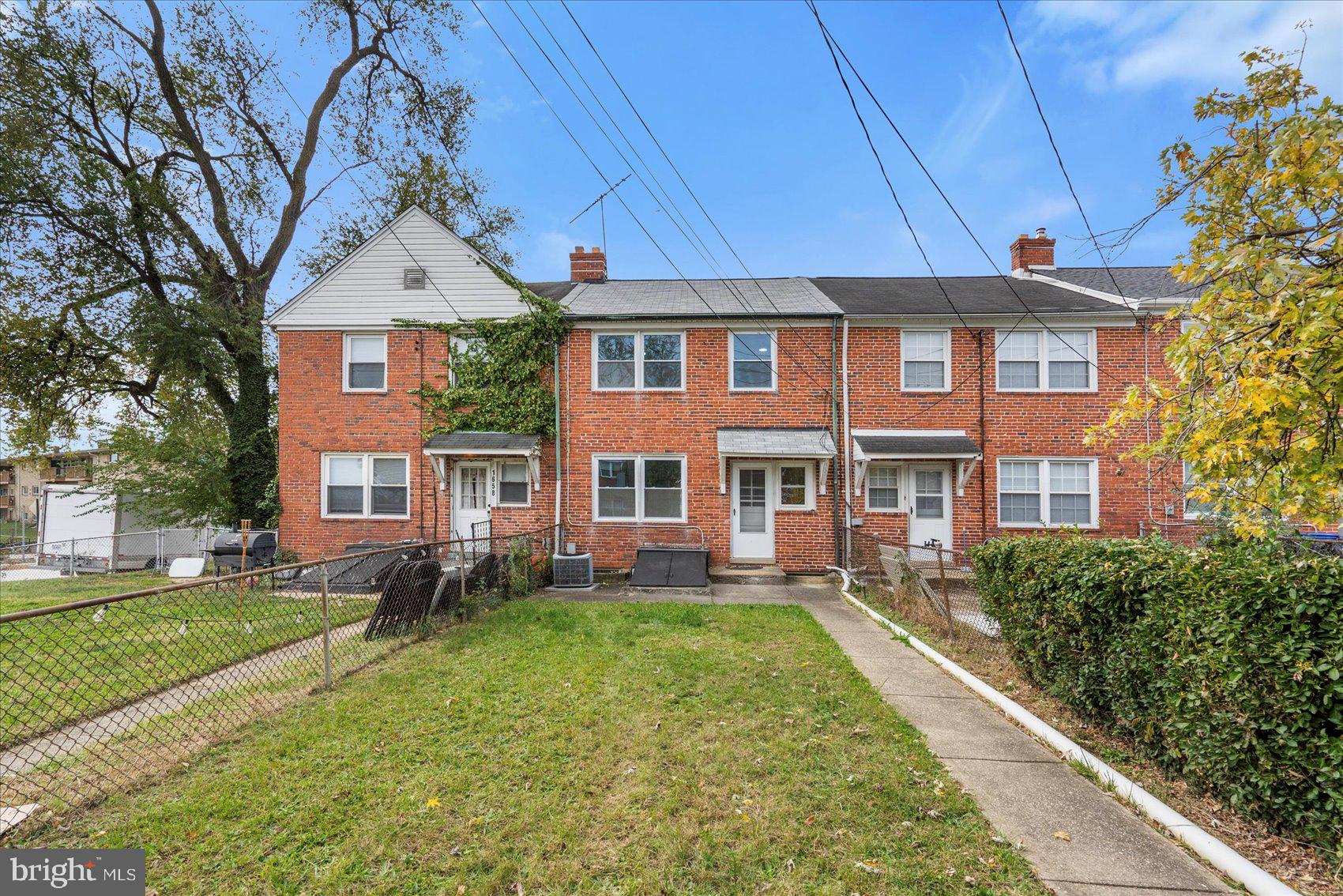 1656 Ramblewood Road Baltimore, MD 21239 - Photo 38 of 40 a front view of a house with a yard