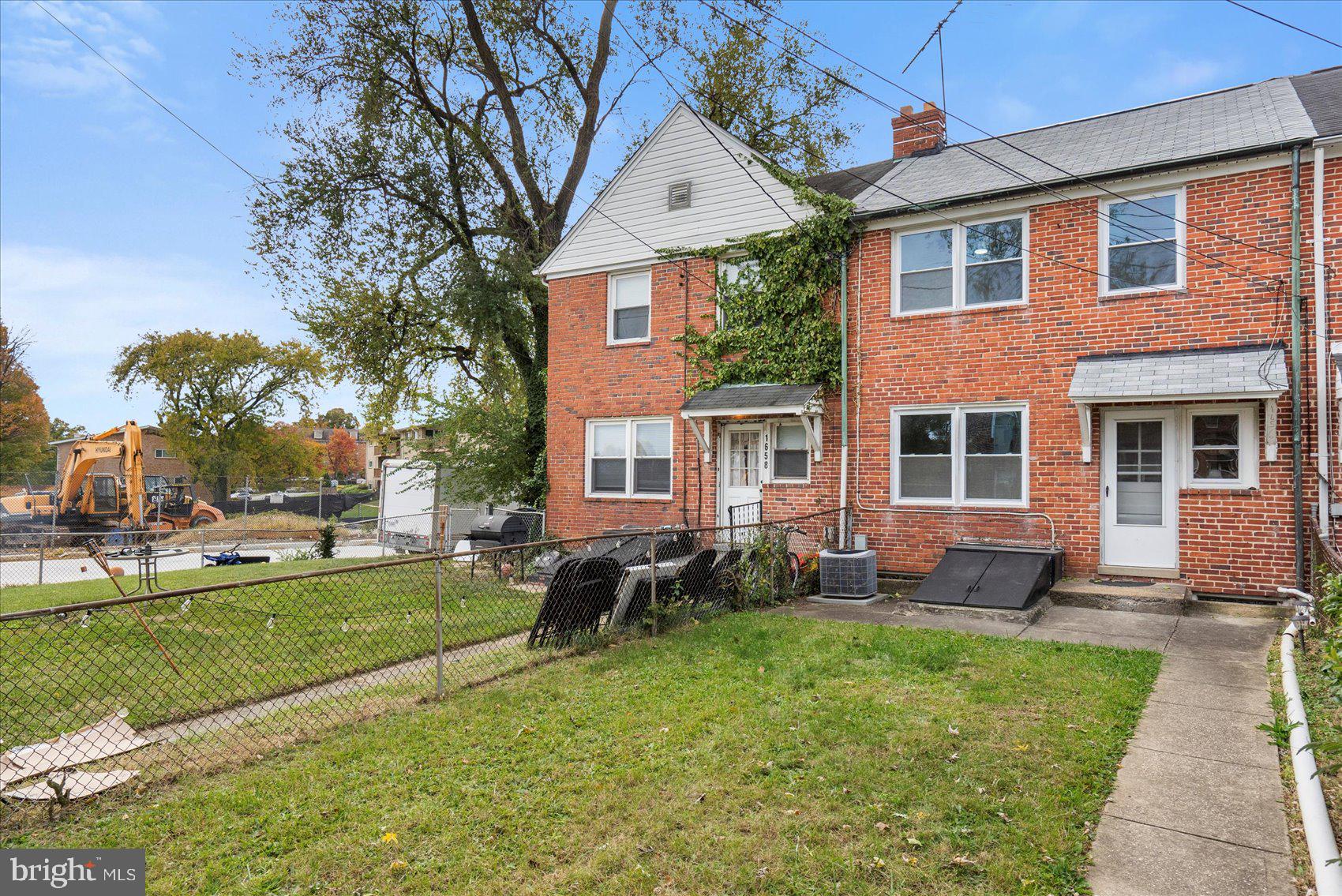 1656 Ramblewood Road Baltimore, MD 21239 - Photo 39 of 40 a front view of a house with a garden and patio