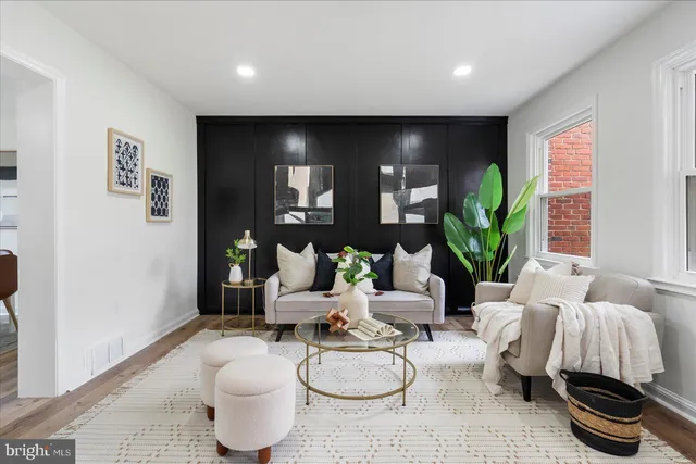 a living room with furniture and a potted plant