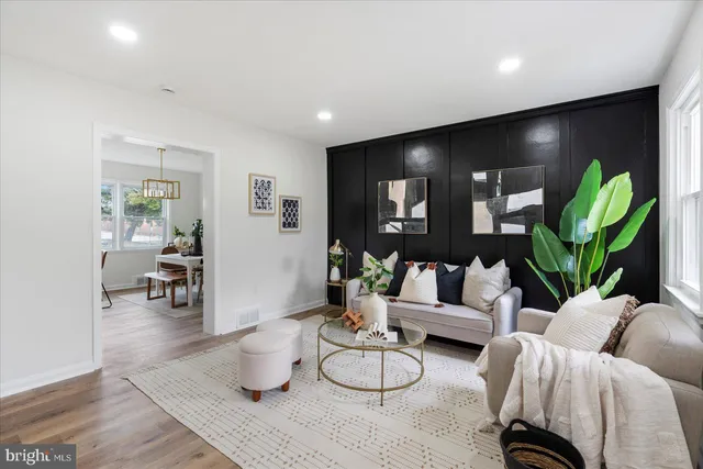 a living room with furniture and a potted plant