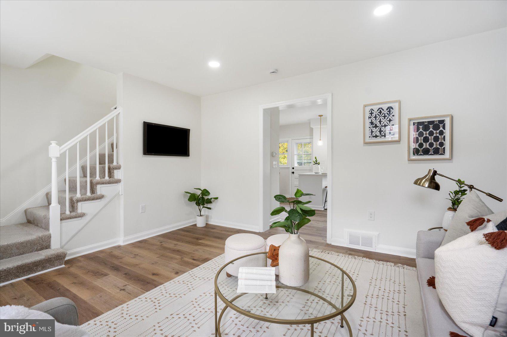 1656 Ramblewood Road Baltimore, MD 21239 - Photo 8 of 40 a living room with furniture and a flat screen tv