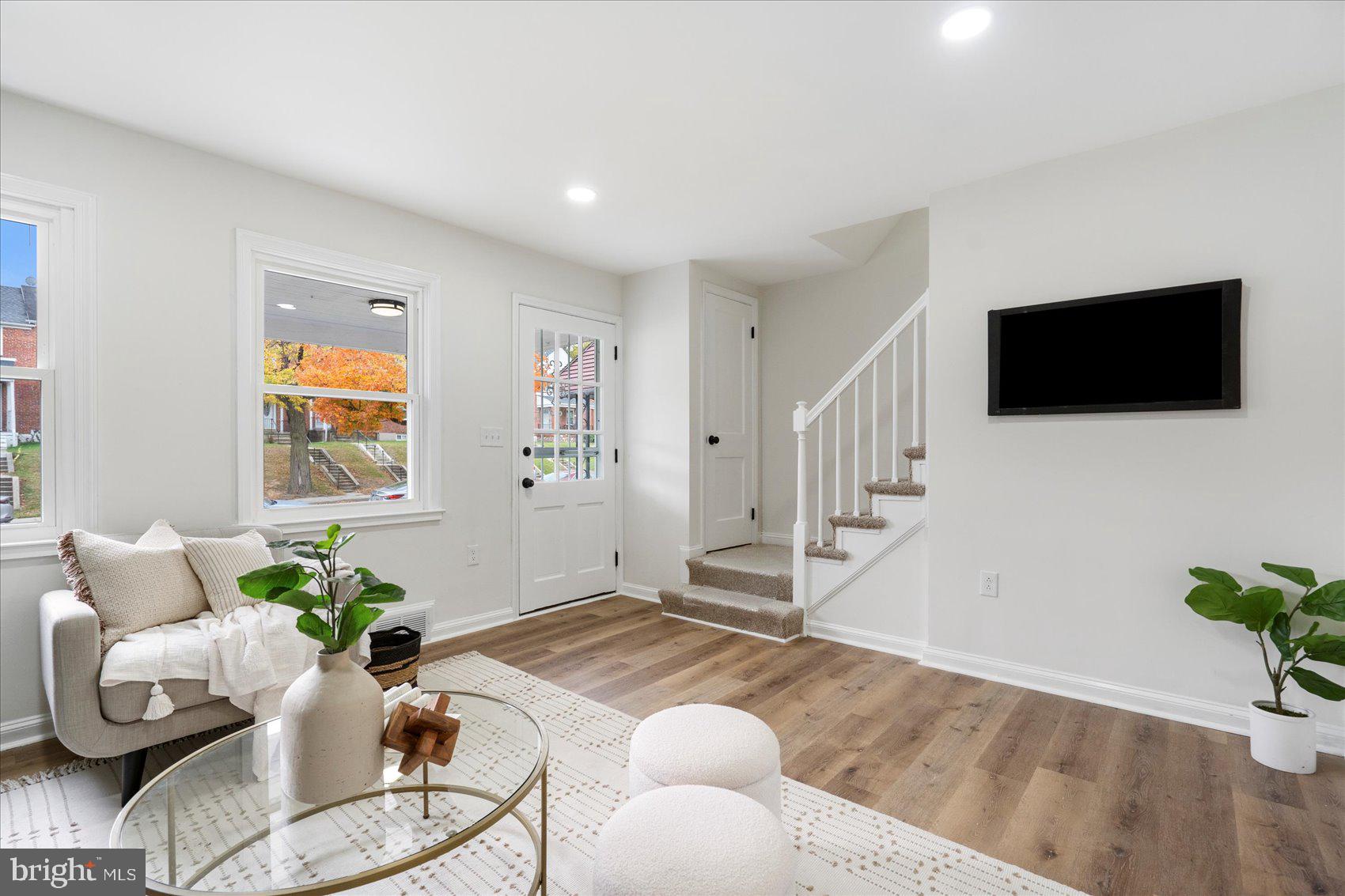 1656 Ramblewood Road Baltimore, MD 21239 - Photo 9 of 40 a living room with furniture and a flat screen tv