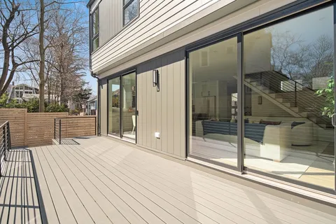 a view of a balcony with wooden floor and fence