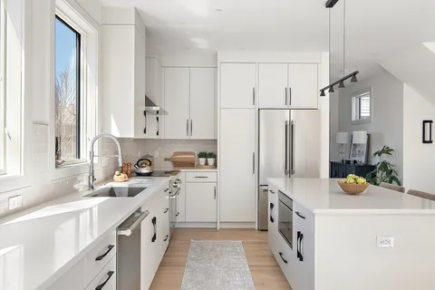 a kitchen with a sink a stove and cabinets