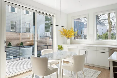 a dining area with a granite countertop sink and a large window
