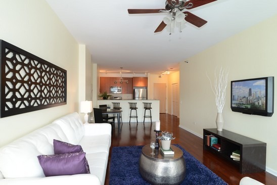 125 South Green Street, Unit 809A Chicago, IL 60607 - Photo 4 of 10 a living room with furniture and a flat screen tv