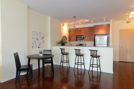 125 South Green Street, Unit 809A Chicago, IL 60607 - Photo 6 of 10 a view of a dining room with furniture and wooden floor