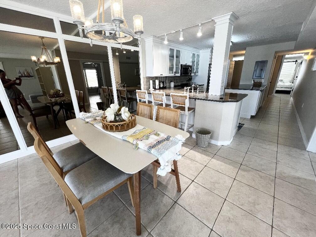3060 North Atlantic Avenue, Unit 701 Cocoa Beach, FL 32931 - Photo 12 of 25 a view of a dining room with furniture