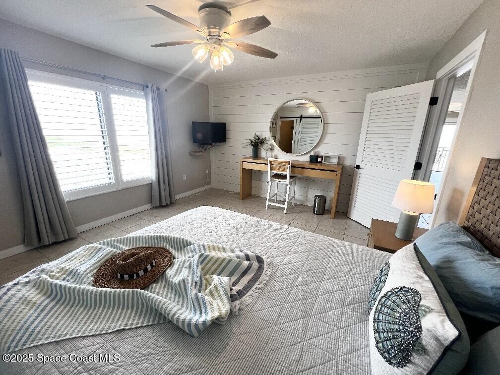 3060 North Atlantic Avenue, Unit 701 Cocoa Beach, FL 32931 - Photo 15 of 25 a living room with furniture a rug and a window