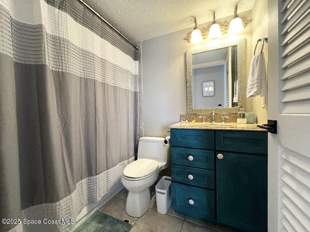3060 North Atlantic Avenue, Unit 701 Cocoa Beach, FL 32931 - Photo 20 of 25 a bathroom with a sink vanity and a mirror
