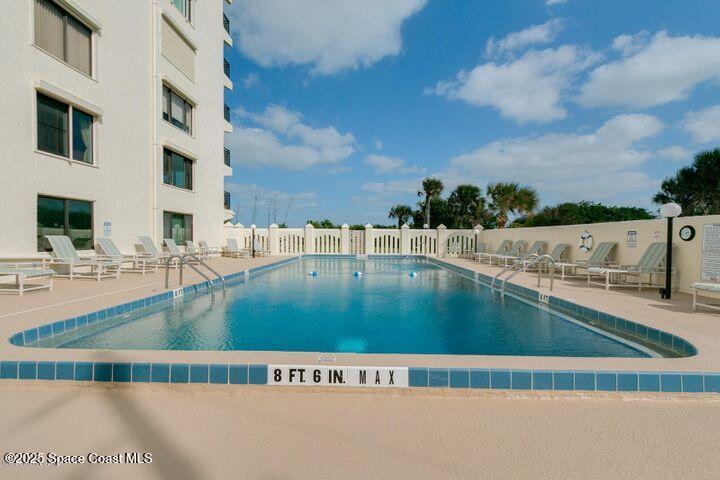 3060 North Atlantic Avenue, Unit 701 Cocoa Beach, FL 32931 - Photo 2 of 25 a view of swimming pool with outdoor seating
