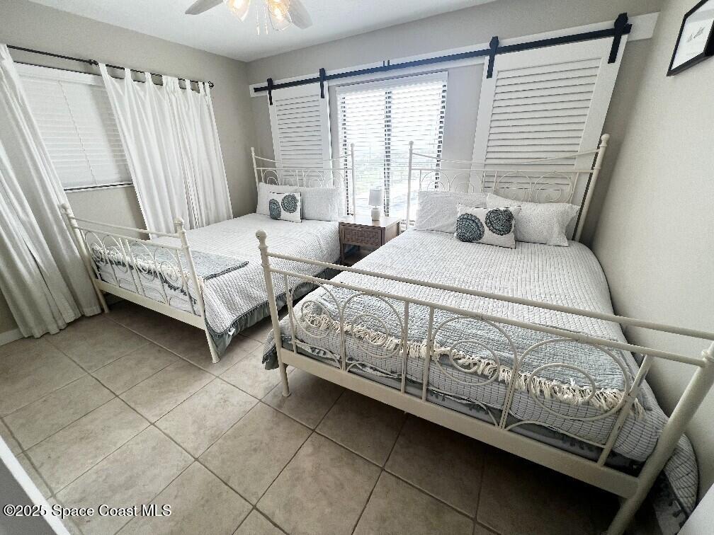 3060 North Atlantic Avenue, Unit 701 Cocoa Beach, FL 32931 - Photo 21 of 25 a bedroom with a bed and a window
