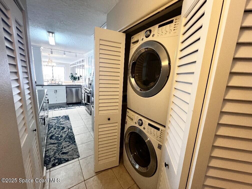 3060 North Atlantic Avenue, Unit 701 Cocoa Beach, FL 32931 - Photo 22 of 25 a view of a bedroom with washer and dryer