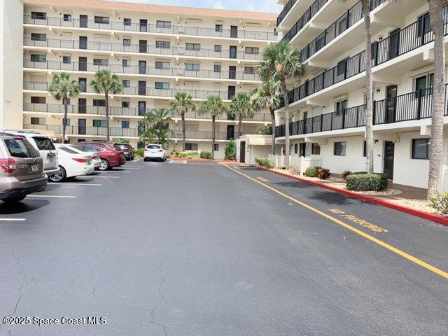 3060 North Atlantic Avenue, Unit 701 Cocoa Beach, FL 32931 - Photo 24 of 25 a view of a street with a cars parked in front of a building