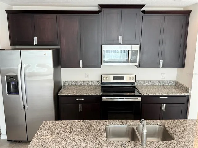 a kitchen with a sink and a refrigerator