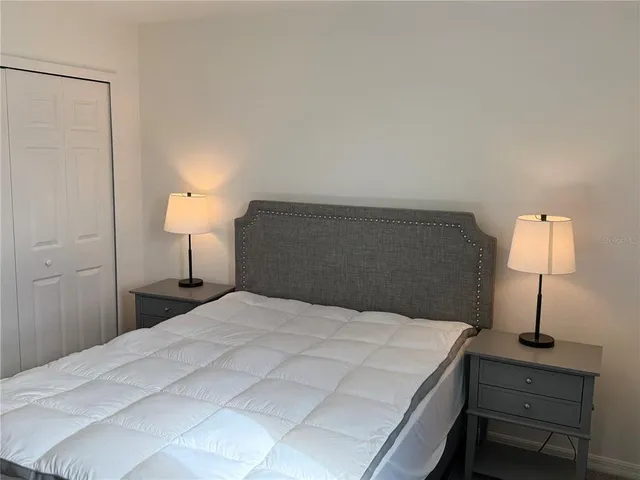 a bedroom with a bed and a lamp