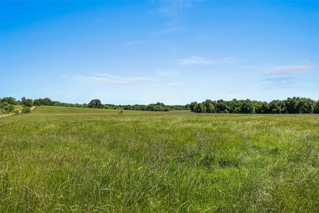 a view of a lake and green valley