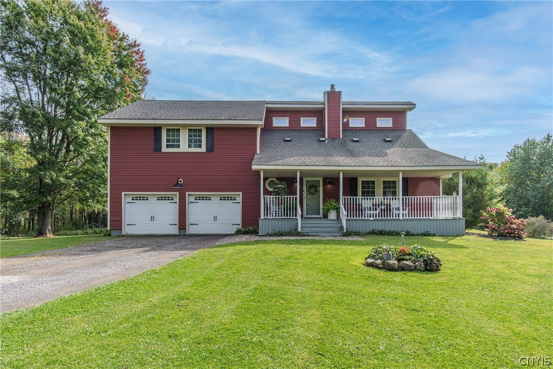 15384 Fuller Road Adams, NY 13606 - Photo 1 of 50 Classic red siding and a welcoming front porch define this multi-level home's traditional exterior design.
