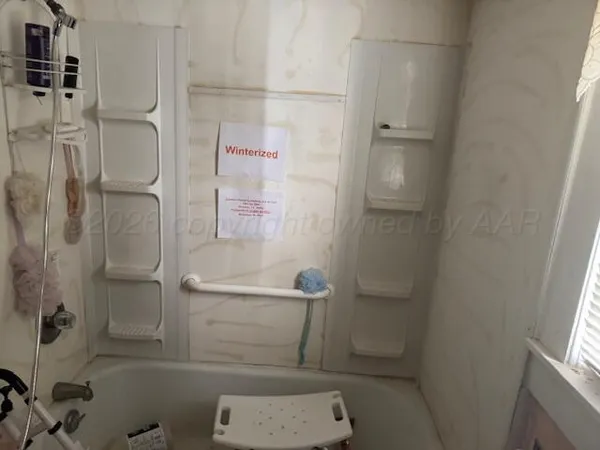 a bathroom with a granite countertop toilet and a shower